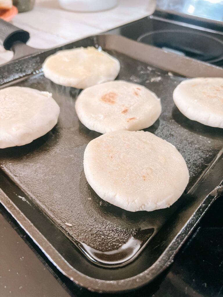 bread dough frying on skillet.
