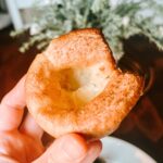 Hand holding up a Yorkshire pudding.