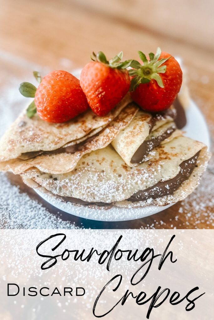 Sourdough discard crepes filled with chocolate and topped with strawberries with text overlay.